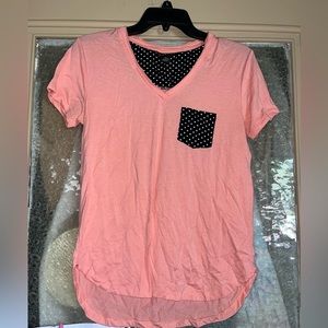 Pink shirt with black and white polka dot pocket